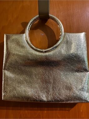 Shimmering gold Metallic Ring-Handle Clutch in leather like material